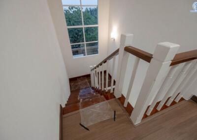 Well lit stairway with wooden floors and modern balusters