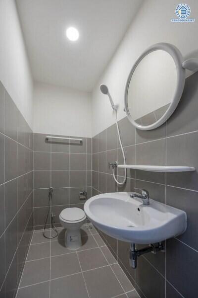 Modern bathroom interior with gray tiles and white fixtures