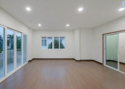Spacious and brightly lit living room with wooden flooring
