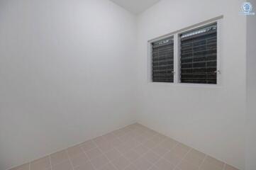 Minimalist bedroom with two windows and tiled floor