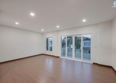 Spacious empty living room with large windows and wooden flooring
