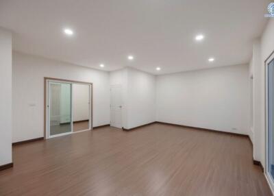 Spacious and brightly lit living room with hardwood floors