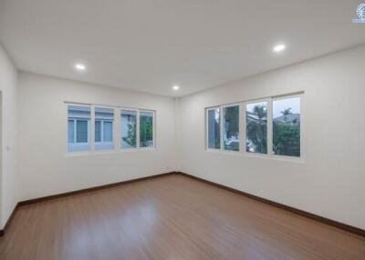 Spacious and well-lit empty bedroom with multiple windows