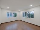 Spacious and well-lit empty bedroom with multiple windows