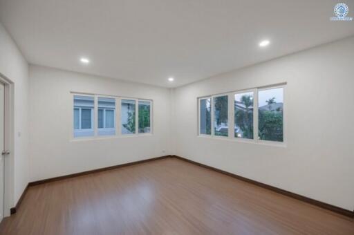 Spacious and well-lit empty bedroom with multiple windows