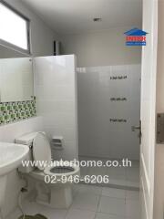 Clean and modern bathroom with white and green tiles