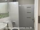 Clean and modern bathroom with white and green tiles