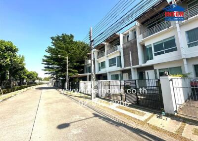Exterior view of modern residential townhouses with clear sky