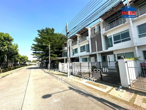 Exterior view of modern residential townhouses with clear sky