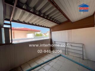 Covered balcony space with seating and open views in a residential property