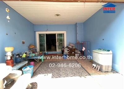 Spacious covered patio area with blue accents and household items