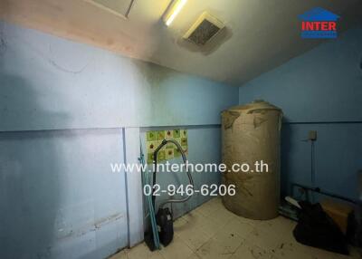 Spacious but poorly maintained utility room with visible mold and clutter
