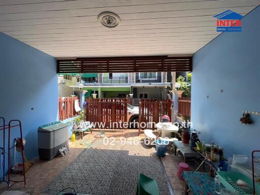 Spacious patio area with tiled flooring and partial roof covering