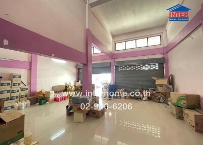 Spacious warehouse interior with high ceiling and organized storage boxes