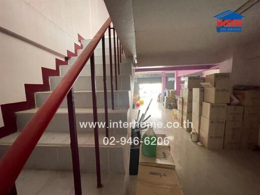 Interior view of a building with staircase and storage boxes