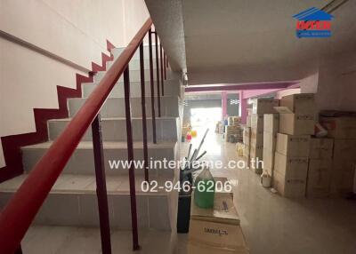 Interior view of a building with staircase and storage boxes
