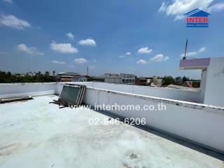 Spacious rooftop area with an open view under clear blue sky