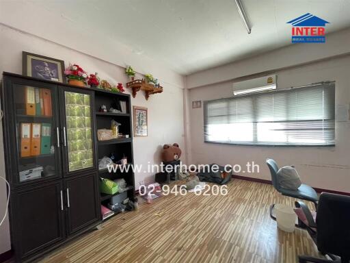 Spacious living room with large storage cabinets and comfortable seating