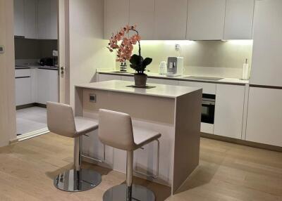 Modern kitchen with bar seating and elegant lighting