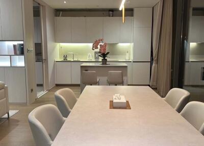 Modern kitchen with integrated dining area featuring sleek design