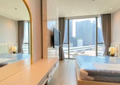 Bright and modern bedroom with large windows and city view