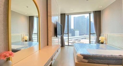 Bright and modern bedroom with large windows and city view