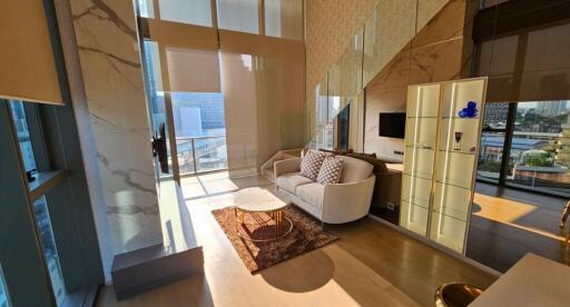 Spacious and modern living room with large windows and city view