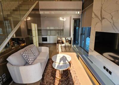 Modern living room with open kitchen and staircase