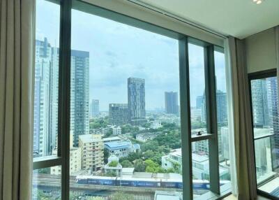 Spacious living room with large windows offering a city view