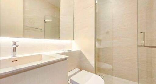 Modern bathroom with beige tiles and glass shower