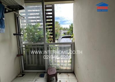 Balcony view with plants and a car outside