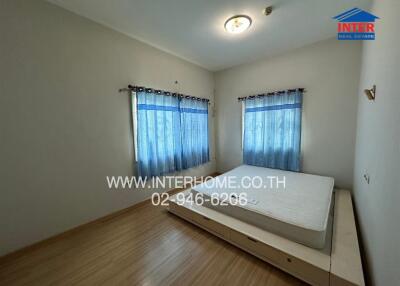 Simple bedroom with bed and blue curtains