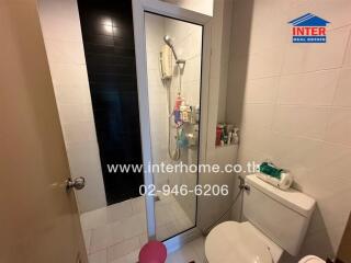 Compact bathroom with a glass shower and white toilet