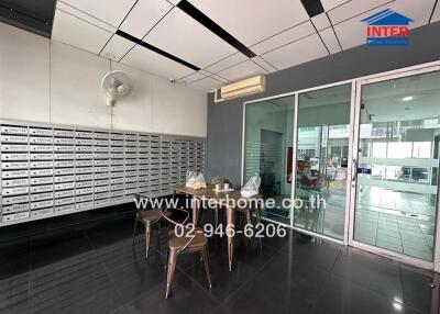 Modern mailroom with table and secure mailboxes
