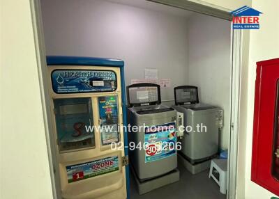 Utility room with vending machines and laundry appliances