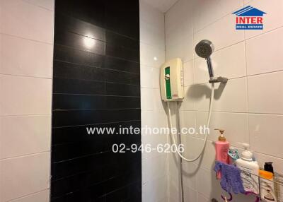 Modern bathroom with black tiles and essential bath amenities
