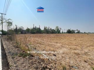 Spacious empty land ready for development under daytime sunshine