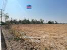 Spacious empty land ready for development under daytime sunshine