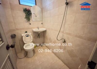 Clean tiled bathroom with modern amenities in a home for sale