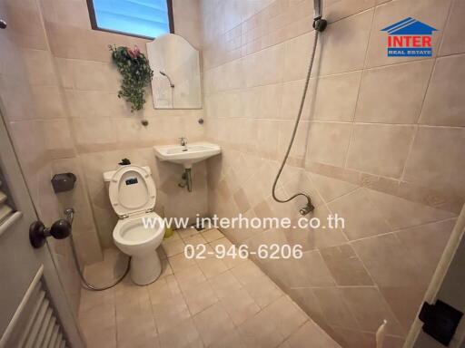 Clean tiled bathroom with modern amenities in a home for sale