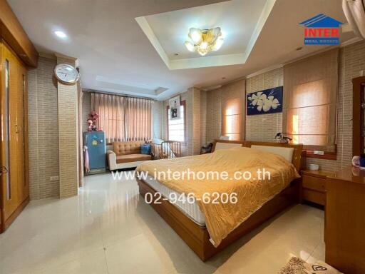 Spacious and well-furnished master bedroom with elegant interior design