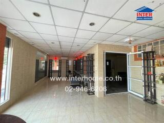 Spacious living room with tile flooring and natural light