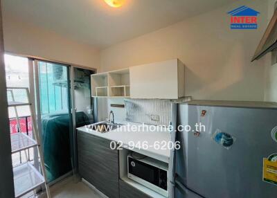 Compact modern kitchen with updated appliances and balcony access