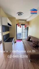 Spacious living room with natural lighting, modern furniture, and balcony access