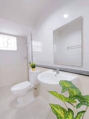 Modern white bathroom with bright lighting