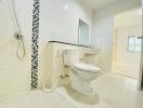 Spacious and modernly designed white bathroom with wall-mounted sink