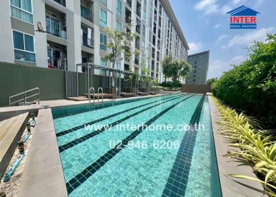 Outdoor swimming pool with apartment buildings in the background