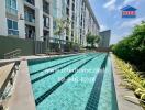 Outdoor swimming pool with apartment buildings in the background