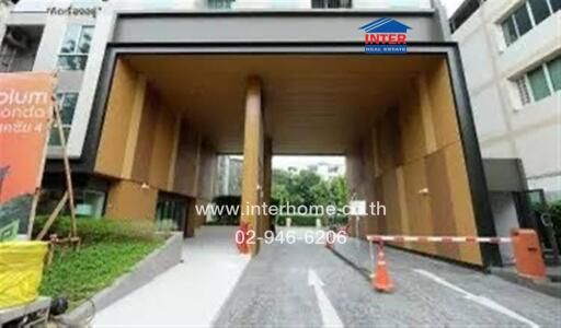 Modern condominium entrance with large archway