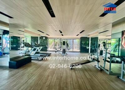 Spacious home gym with modern equipment and wooden floors